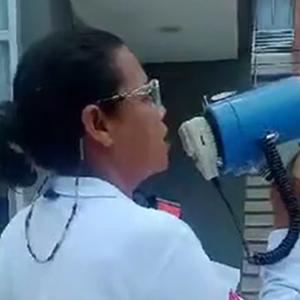 La mujer con el megáfono en mano realizando su labor en el norte de la ciudad