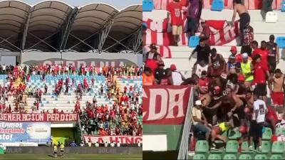Imágenes de la pelea entre hinchas en la tribuna.