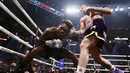 Canelo Álvarez propinando un fuerte golpe a Jermell Charlo en su cuerpo