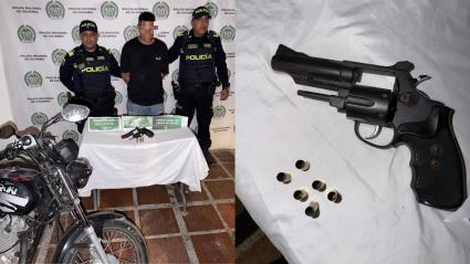 Fotografía de uno de los capturados junto con un arma incautada.